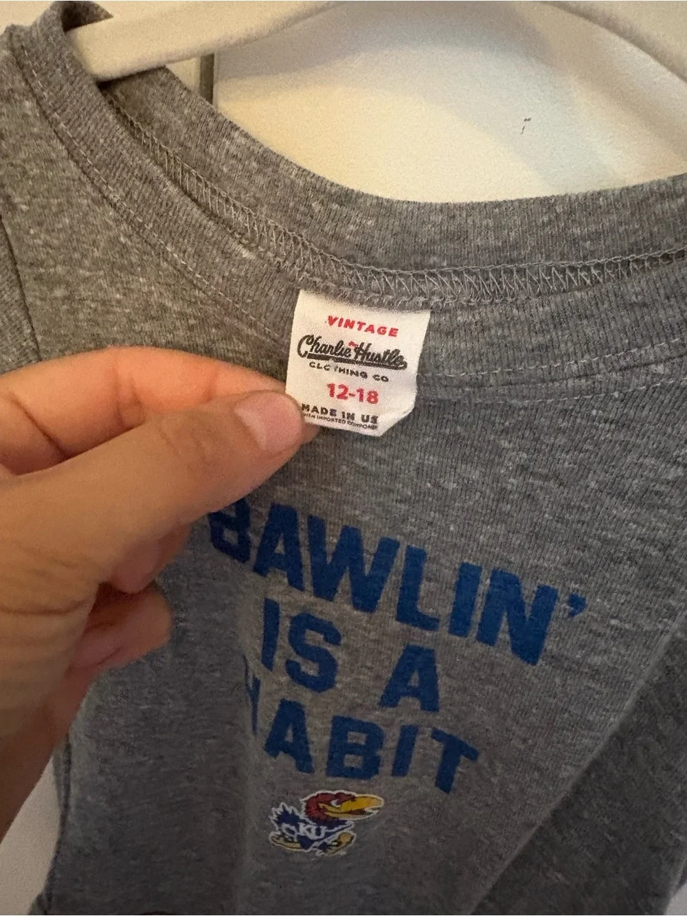 Charlie Hustle Gray Baby Onesie with Blue 'Bawlin’ Is A Habit' and Jayhawk Logo